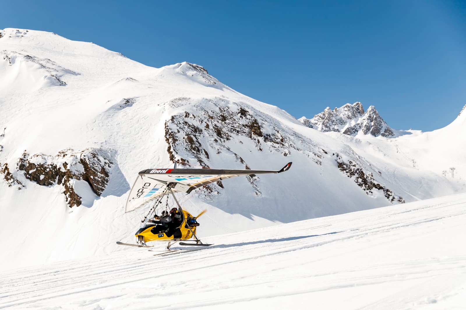 Skiers lifting off on glider at Tignes ski resort